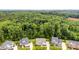 The house sits near a large wooded area providing privacy and a natural landscape at 8709 Raven Top Dr, Mint Hill, NC 28227