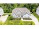 An aerial view of a home showcases its manicured lawn, landscaping, and tree line at 8709 Raven Top Dr, Mint Hill, NC 28227