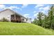 A green backyard has a covered deck and stairs from the second story at 8709 Raven Top Dr, Mint Hill, NC 28227