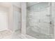 Modern bathroom featuring a glass door shower with a built-in seat and tiled walls at 8709 Raven Top Dr, Mint Hill, NC 28227