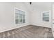 Bright bedroom featuring neutral carpet, two large windows, and an overhead fan at 8709 Raven Top Dr, Mint Hill, NC 28227