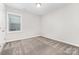Carpeted bedroom with natural light from a window, painted in neutral colors at 8709 Raven Top Dr, Mint Hill, NC 28227