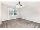 Bedroom with neutral colored carpet, a ceiling fan, and window to let in natural light at 8709 Raven Top Dr, Mint Hill, NC 28227