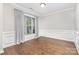 Bright dining room with hardwood floors, decorative molding, and large window with draperies at 8709 Raven Top Dr, Mint Hill, NC 28227