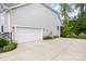 A modern home shows a two-car garage and driveway flanked by landscaping at 8709 Raven Top Dr, Mint Hill, NC 28227
