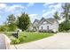 Traditional home with well-manicured lawn, mature trees, and paved driveway at 8709 Raven Top Dr, Mint Hill, NC 28227