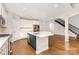 Open concept kitchen with stainless steel appliances, large island, and hardwood floors at 8709 Raven Top Dr, Mint Hill, NC 28227