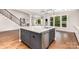 Modern kitchen featuring a large island with a sink, stainless steel appliances, and hardwood flooring at 8709 Raven Top Dr, Mint Hill, NC 28227