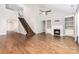 Large living room featuring a fireplace, hardwood floors, a staircase, and high ceilings with a ceiling fan at 8709 Raven Top Dr, Mint Hill, NC 28227