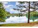 Scenic pond view with calm water reflecting the surrounding trees and sky at 8709 Raven Top Dr, Mint Hill, NC 28227