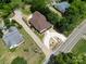 Aerial view of home with a freshly paved driveway, mature trees, and a well maintained lawn at 933 Old Charlotte Rd, Concord, NC 28027