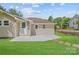 This home features a well-maintained lawn, a concrete patio, and a white back door entrance at 933 Old Charlotte Rd, Concord, NC 28027