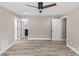 Open bedroom features hardwood floors, a modern ceiling fan, and access to the bathroom at 933 Old Charlotte Rd, Concord, NC 28027