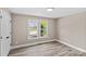 Well-lit bedroom with hardwood floors and natural light at 933 Old Charlotte Rd, Concord, NC 28027