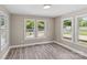 Bright bedroom with hardwood floors and multiple windows at 933 Old Charlotte Rd, Concord, NC 28027