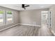 Spacious bedroom with hardwood floors, modern ceiling fan, and natural light from multiple windows at 933 Old Charlotte Rd, Concord, NC 28027
