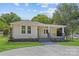 Well-maintained home showcasing a cozy covered porch and lovely front yard landscaping at 933 Old Charlotte Rd, Concord, NC 28027