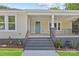 Charming front porch featuring stylish steps, black railing, and a vibrant blue front door at 933 Old Charlotte Rd, Concord, NC 28027