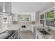 Modern kitchen featuring white cabinets, granite countertops, and stainless steel appliances at 933 Old Charlotte Rd, Concord, NC 28027