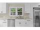 Bright kitchen features stainless steel appliances, granite countertops, and a window offering natural light at 933 Old Charlotte Rd, Concord, NC 28027
