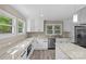 Bright kitchen features granite countertops, stainless steel appliances, and white cabinets at 933 Old Charlotte Rd, Concord, NC 28027
