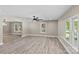 Bright, open living room with hardwood floors, modern lighting, and large windows at 933 Old Charlotte Rd, Concord, NC 28027