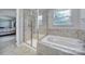 Bathroom featuring a glass-enclosed shower and soaking tub at 1012 Kings Bottom Dr, Fort Mill, SC 29715