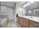 Bathroom with a double sink vanity, soaking tub, and neutral tile at 1012 Kings Bottom Dr, Fort Mill, SC 29715