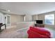 Carpeted bonus room with a red couch and TV at 1012 Kings Bottom Dr, Fort Mill, SC 29715