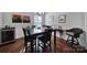 Elegant dining room with a dark wood table set for four, complemented by a wine fridge at 1012 Kings Bottom Dr, Fort Mill, SC 29715