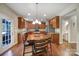 Eat-in kitchen with wooden cabinets, granite countertops, stainless steel appliances, wooden table and chairs at 1012 Kings Bottom Dr, Fort Mill, SC 29715