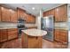 Well-equipped kitchen features wooden cabinets, granite countertops, a stainless steel refrigerator, and a center island at 1012 Kings Bottom Dr, Fort Mill, SC 29715