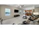 Spacious living room with a ceiling fan, large windows, plush sofas, and a view of the eat-in kitchen at 1012 Kings Bottom Dr, Fort Mill, SC 29715