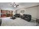 Open-concept living room with plush sofas, a coffee table, and a view of the adjoining eat-in kitchen at 1012 Kings Bottom Dr, Fort Mill, SC 29715