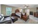 Spacious main bedroom features a ceiling fan, windows, and wooden furniture at 1012 Kings Bottom Dr, Fort Mill, SC 29715