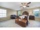 Large main bedroom boasts multiple windows, ceiling fan, and stylish wood furniture at 1012 Kings Bottom Dr, Fort Mill, SC 29715