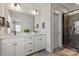 Bathroom showcasing dual sinks, sleek countertops, and a modern glass-enclosed shower at 1036 Riverwalk Pkwy, Rock Hill, SC 29730