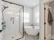 Beautiful bathroom featuring a soaking tub, glass enclosed shower and large windows at 1036 Riverwalk Pkwy, Rock Hill, SC 29730
