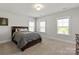 Bedroom features carpet flooring, natural light, and a wood-framed bed, creating a cozy atmosphere at 1036 Riverwalk Pkwy, Rock Hill, SC 29730
