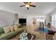 Bright, open living space featuring hardwood floors, a comfortable sofa, and a large-screen TV at 1036 Riverwalk Pkwy, Rock Hill, SC 29730
