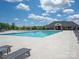 Large community pool with plenty of seating, clear blue water, and a view of the clubhouse at 1036 Riverwalk Pkwy, Rock Hill, SC 29730