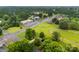Aerial view of a neighborhood with greenery, commercial buildings, and roads showcases the community layout at 103A N Tracy St, Kings Mountain, NC 28086