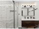 Modern bathroom featuring dual sinks, a tile shower with a glass enclosure, and decorative lighting at 103A N Tracy St, Kings Mountain, NC 28086