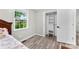Bedroom featuring light gray walls, wood floors, a closet, and a window with tree views at 103A N Tracy St, Kings Mountain, NC 28086