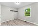 Bedroom featuring light gray walls, wood floors, and a window with tree views at 103A N Tracy St, Kings Mountain, NC 28086