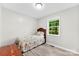 Bedroom featuring light gray walls, wood floors, and a window with tree views at 103A N Tracy St, Kings Mountain, NC 28086