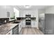 Modern kitchen featuring stainless steel appliances, granite countertops, and a sleek backsplash at 103A N Tracy St, Kings Mountain, NC 28086