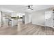Open concept living room and kitchen with hardwood floors, ceiling fan, and stainless steel appliances at 103A N Tracy St, Kings Mountain, NC 28086