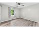 Bright main bedroom featuring a ceiling fan, light gray walls, and wood floors at 103A N Tracy St, Kings Mountain, NC 28086