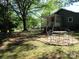 A beautifully landscaped backyard with a dining set on a brick pad and a green lawn at 1051 S Brady Ave, Newton, NC 28658